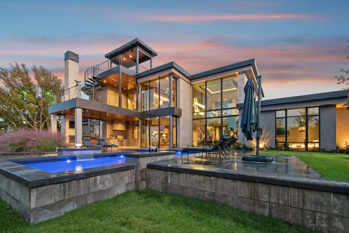 A bespoke contemporary residential estate at dusk, representative of ArchPermits' custom residential permit drawings.